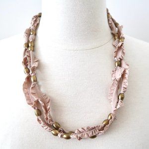 TWO A ruffled elastic & brass bead necklace